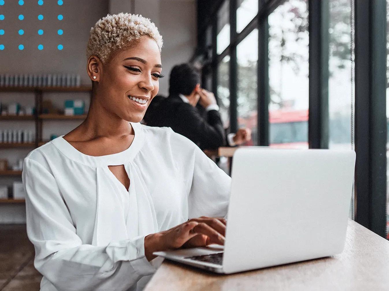 woman working on a laptop at a coffee shop